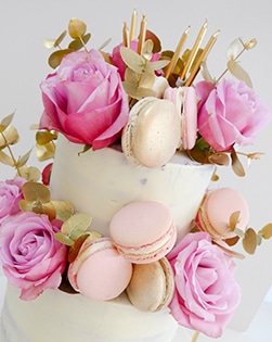 Semi naked cake with roses and macaroons